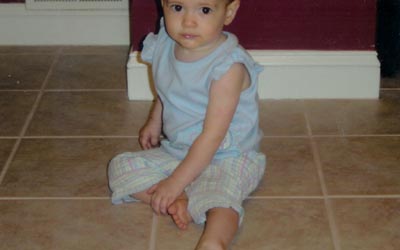 Finished ceramic tile kitchen floor with child